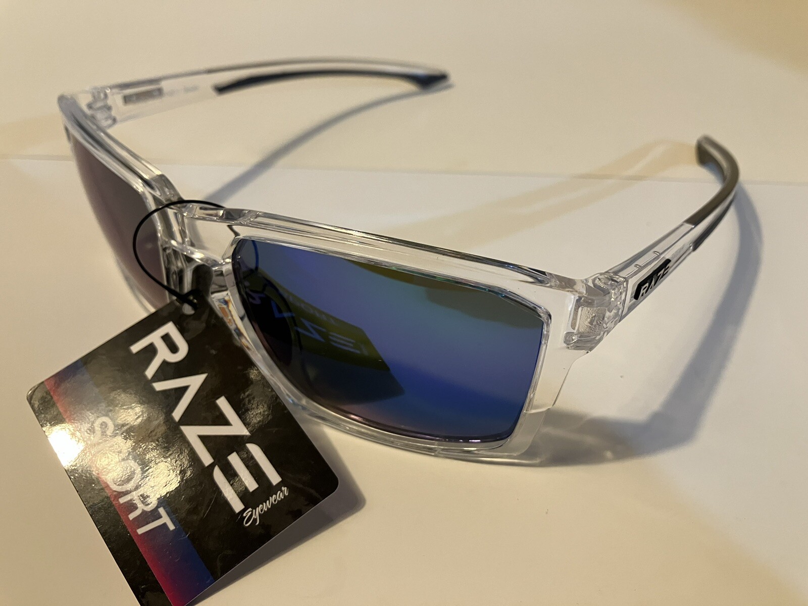 RAZE Eyewear Sunglasses Journey mirrored blue lens clear frame 26922
