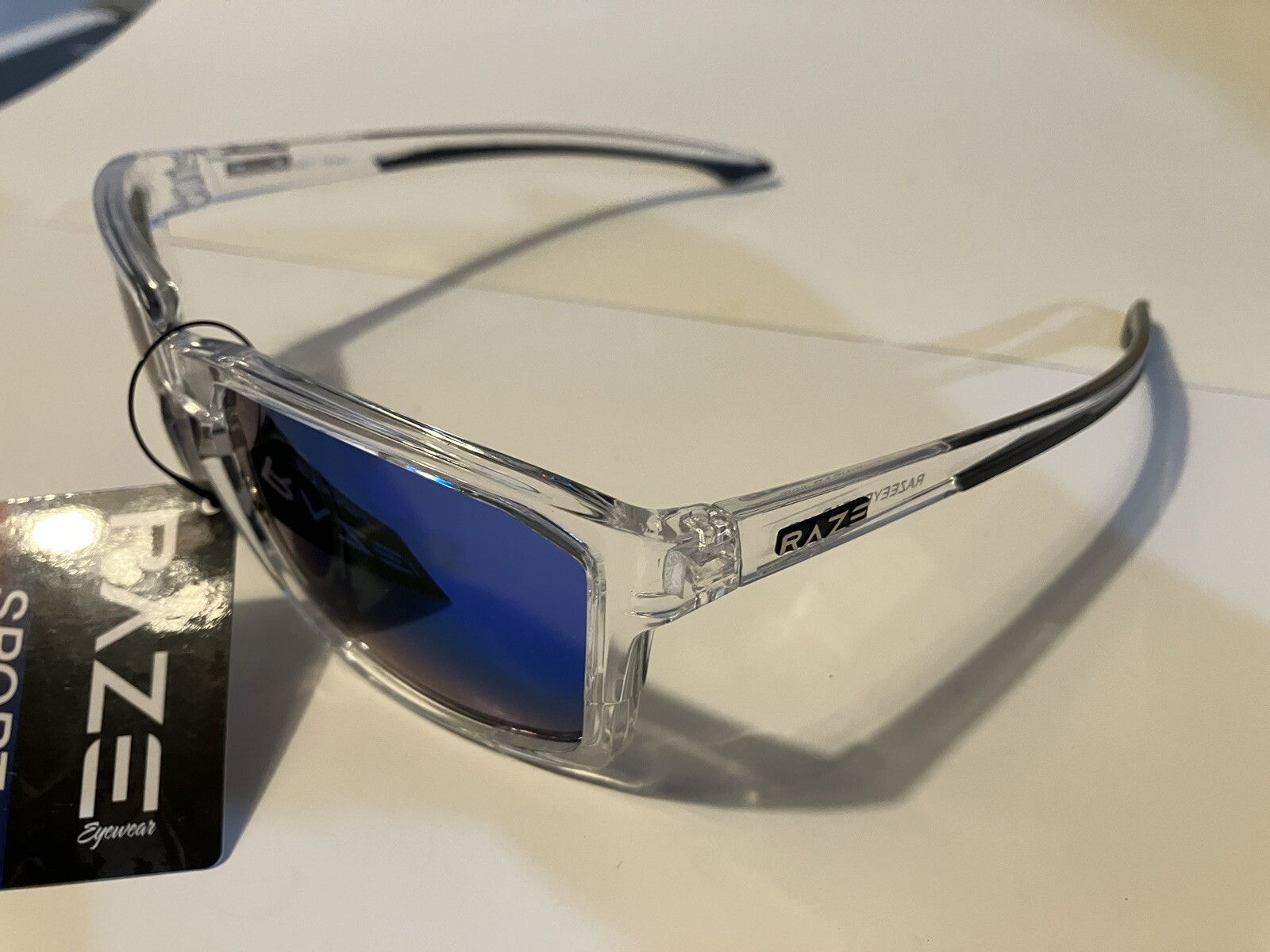 RAZE Eyewear Sunglasses Journey mirrored blue lens clear frame 26922