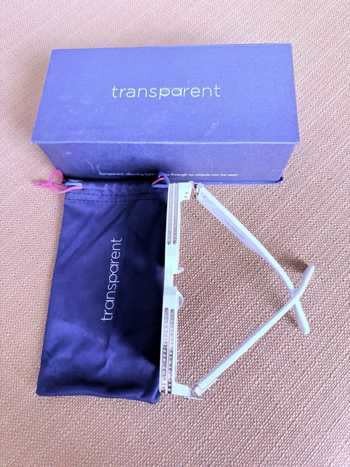 DESIGNER: Transparent Devon Sunglasses with gold detail. Box included.