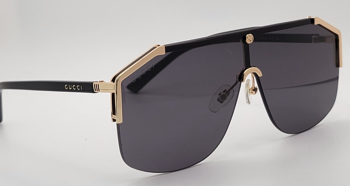 Gucci GG0291S Men’s Sunglasses Oversized Shield Black/Gold Metal Frame Gray Lens