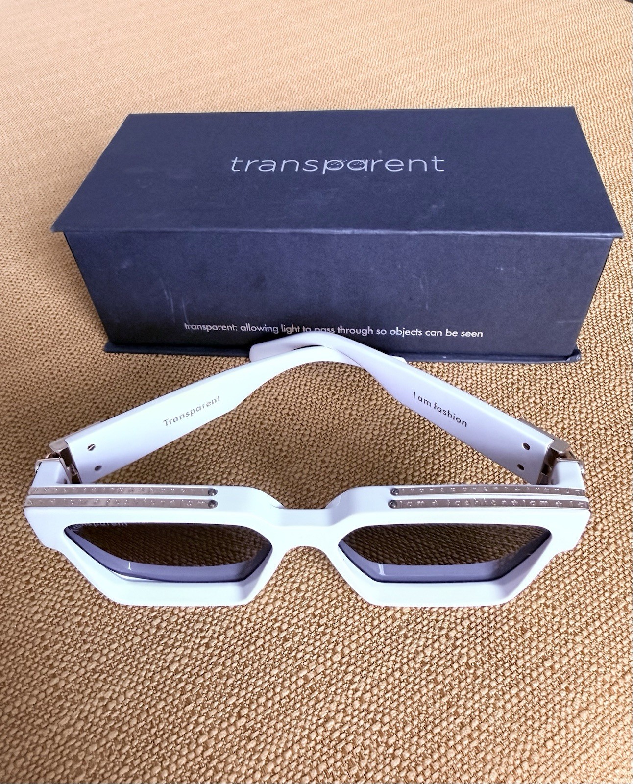 DESIGNER: Transparent Devon Sunglasses with gold detail. Box included.