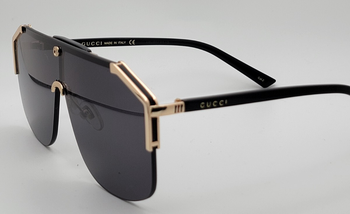 Gucci GG0291S Men’s Sunglasses Oversized Shield Black/Gold Metal Frame Gray Lens