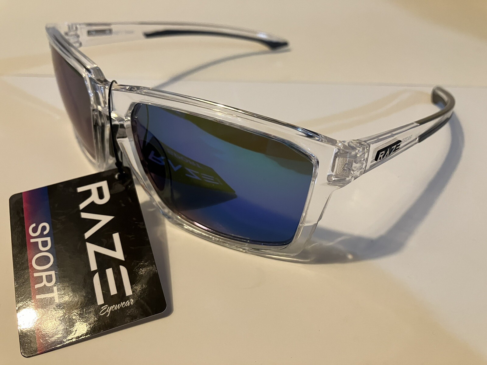 RAZE Eyewear Sunglasses Journey mirrored blue lens clear frame 26922