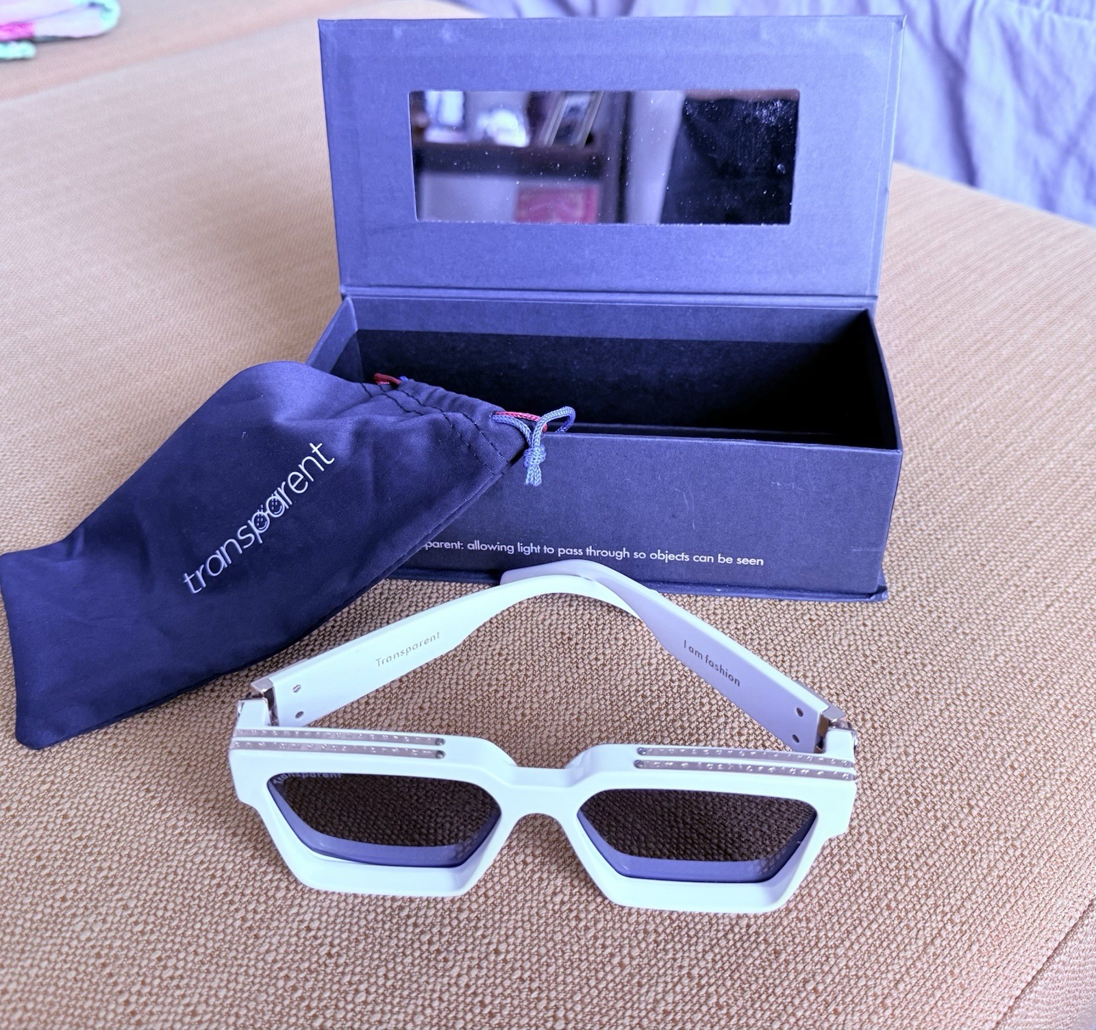 DESIGNER: Transparent Devon Sunglasses with gold detail. Box included.