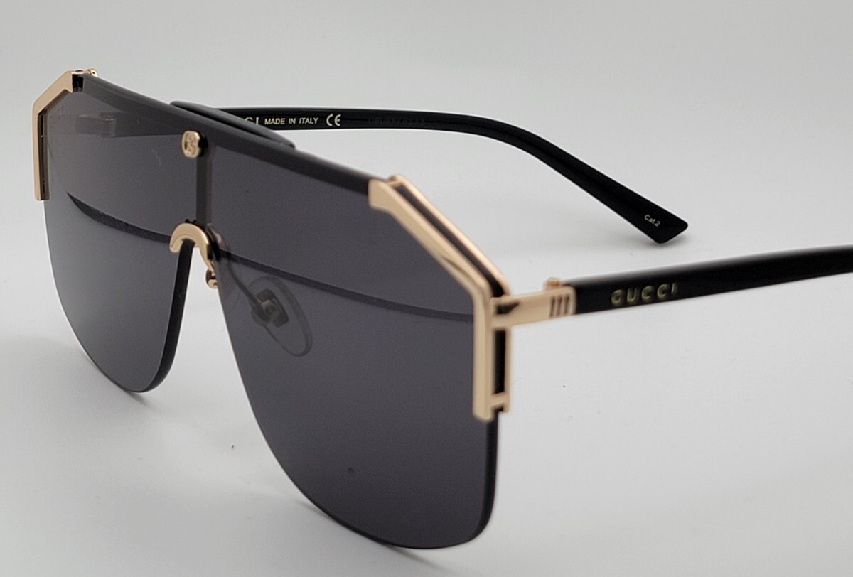 Gucci GG0291S Men’s Sunglasses Oversized Shield Black/Gold Metal Frame Gray Lens